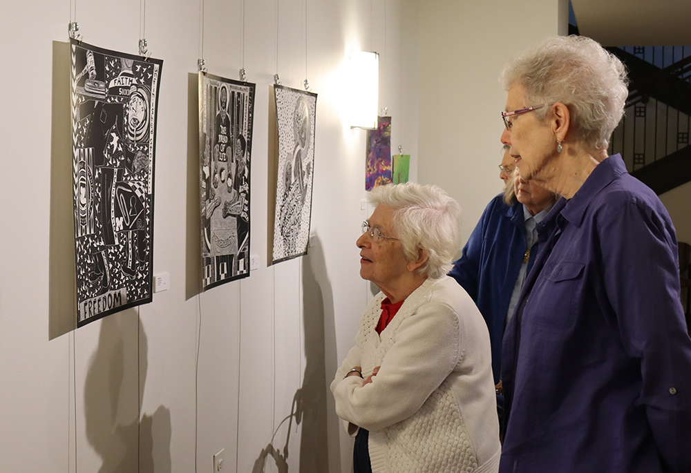 Srs. Betty Leon and Monica Stuhlreyer view artwork on display at the Prison Creative Arts Project's exhibition at the Sisters, Servants of the Immaculate Heart of Mary's Motherhouse Gallery. (Courtesy of Kameryn Gannon/IHM Sisters)