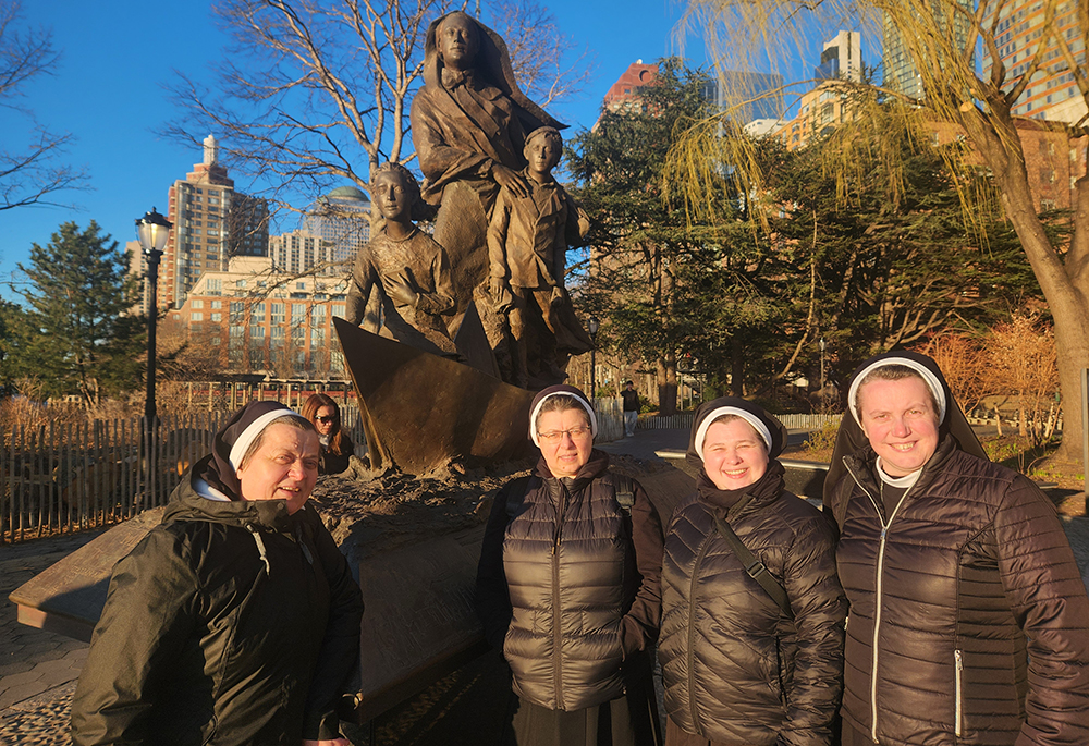 Visiting Ukrainian Sisters of the Order of Sr. Basil the Great in front of a statue to Mother Frances Xavier Cabrini, the patron saint of immigrants in Battery Park, lower Manhattan, New York City. From left to right are Sr. Lucia Murashko, Mother Sevastiana Karvatska, Sr. Anna Andrusiv and Sr. Inokentia Bratziv. (GSR photo/Chris Herlinger)