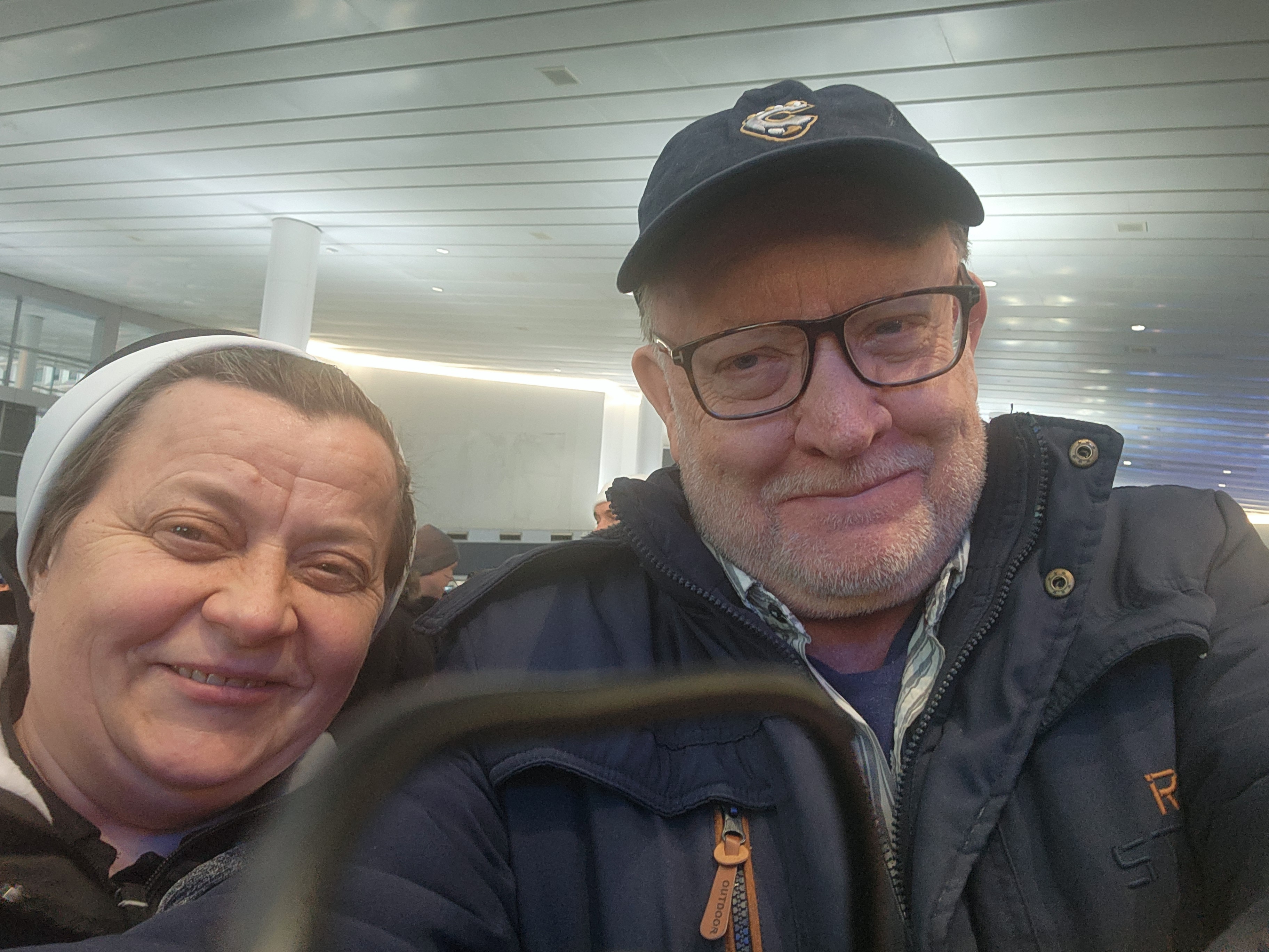 Sr. Lucia Murashko, a member of Sisters of the Order of St. Basil the Great, and GSR international correspondent Chris Herlinger pose for a photo before boarding the Staten Island Ferry in New York City. Murashko and other sisters hosted Herlinger at their convent in Zaporizhzhia, Ukraine, in February 2024. (GSR photo/Chris Herlinger)