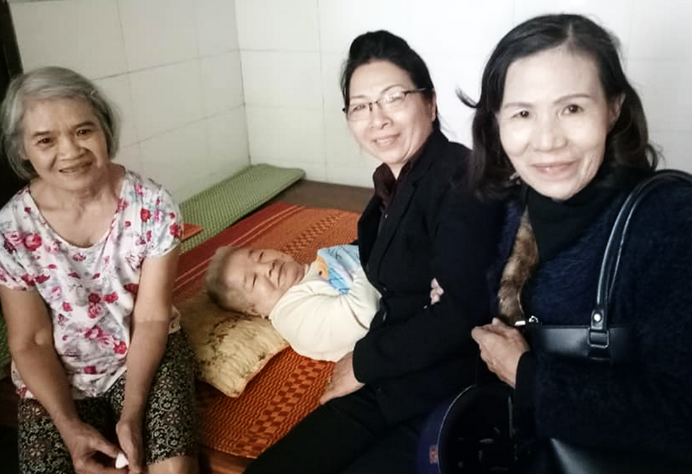 Maria Madeline Do Thi Ngoc, right, and another former nun visit older patients in Hue, Vietnam, on Dec. 20, 2025. (Joachim Pham)