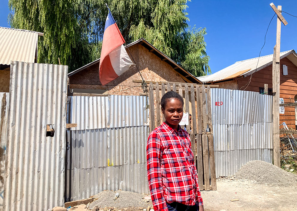 "I don't want to return," said Evena Promesse, a Haitian woman and resident of the camp, standing in front of her home. "I have no family in my country because they all traveled elsewhere." (GSR photo/David Agren) 