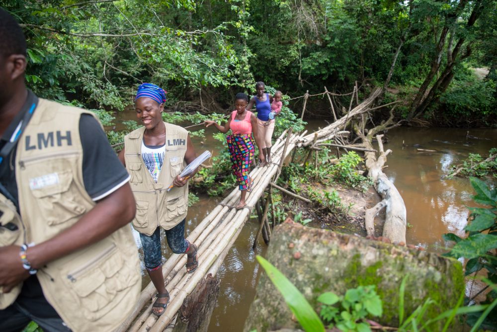In Liberia, nearly 30% of the population lives more than 5 kilometers (3 miles) from the nearest health facility. Since 2007, Last Mile Health has partnered with the Ministry of Health to build a workforce of community health workers who cross footbridges and canoe rivers to bring life-saving care to remote communities. The group now serves every county nationwide. (©Last Mile Health)