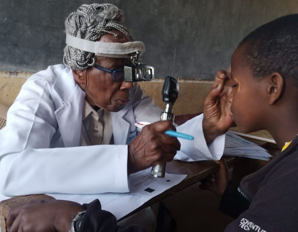 Dr. Sr. Marlene Long gives a patient an eye exam during the Primary School Eye Health Project in Ngong, Kenya in the early 2000s. (Courtesy of Marlene Long)