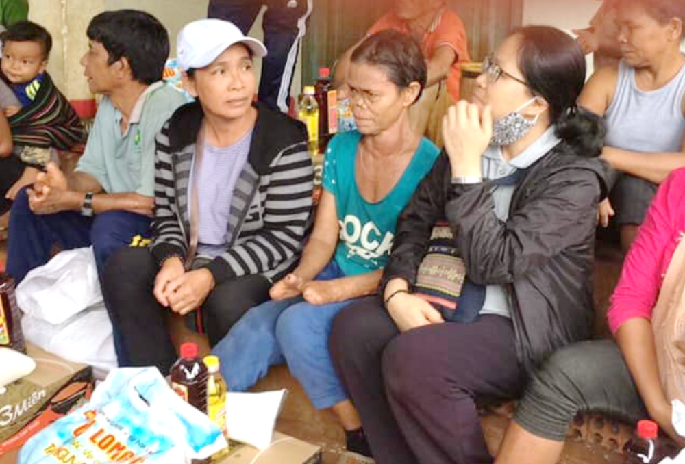 Former leprosy patients receive food and gather around Sr. Mary Magdalene Le Kim Phuong (wearing glasses) in Da Nang on May 30, 2026. (Joachim Pham)