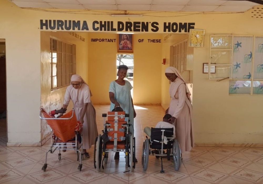 Srs. Rosily Kokkaden, Sr. Anne Hiuhu and staff member Beatrice Lesayeiye interact with children at Huruma Children's Home in Wamba, Kenya. (Lourine Oluoch)