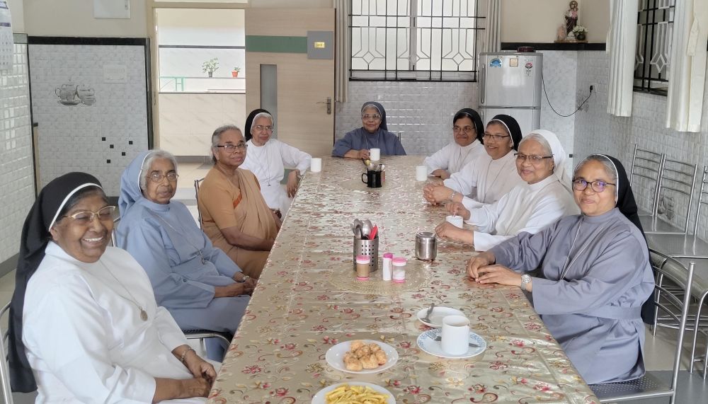 Members of the retired sisters' community pose for a photo in the dining room at Elizabeth Care Home in Bengaluru, southern India. (George Kommattam)