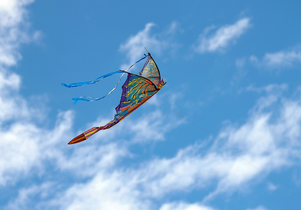 Butterfly shaped kite flying in the sky (Unsplash/Liz Morgan)