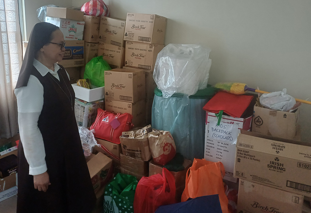 Sr. Milaluna Moralde Arranchado checks donated food, clothing and other supplies for homeless people served by the Carmelite Missionaries in Quezon City, Philippines. (Oliver Samson)