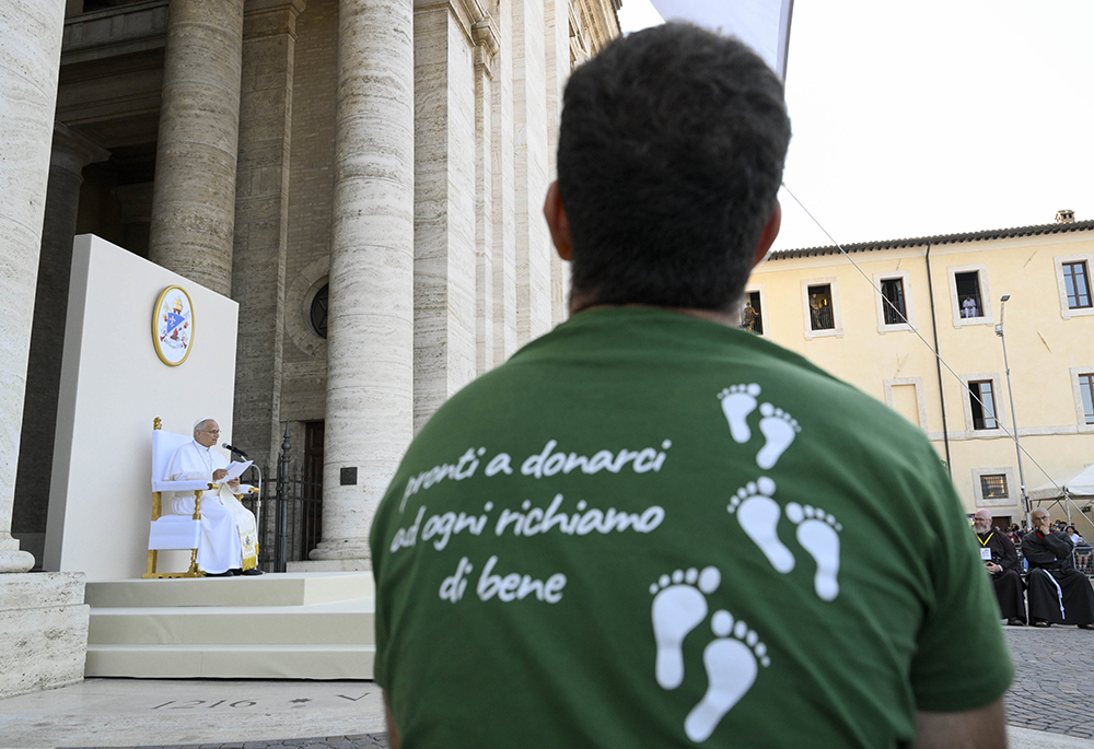 A young man listens to Pope Leo XIV during a meeting between the pope and young people taking part of the "Go! Franciscan Youth Meeting 2026" in Piazza Santa Maria degli Angeli in Assisi, Italy, Aug. 6, 2026. (OSV News/Vatican Media/Simone Risoluti)