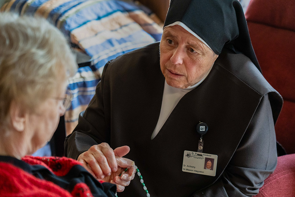 A Carmelite Sister comforts a resident Aug. 21, 2026, at St. Patrick's Residence in Naperville, Ill. (OSV News/Courtesy of Becket)