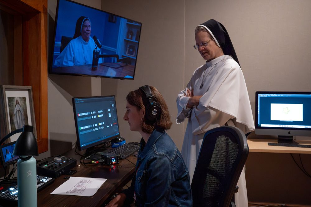 Natalie Kolano, an Openlight Media staff member who edits clips of "Dominican Sisters Open Mic" podcast for TikTok and Instagram, listens to a podcast in the production room in Ann Arbor, Michigan, with Sr. John Dominic Rasmussen. (Courtesy of Openlight Media) 
