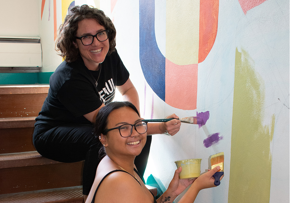 St. Joseph Sr. Bethany Welch paints with one of the transitional housing residents. (Courtesy of Cathie Meighan)