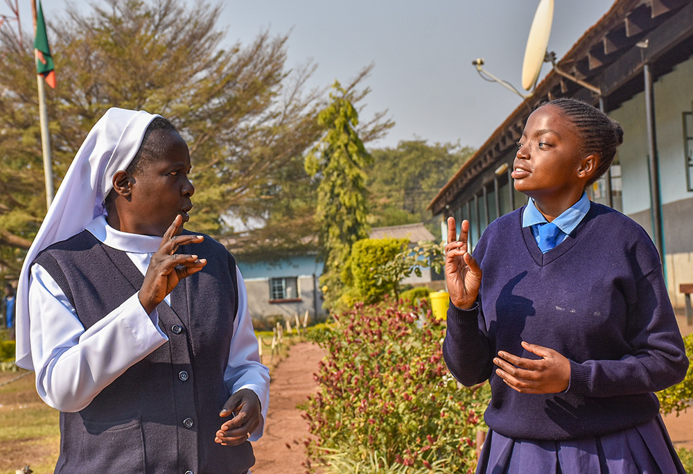 Baptistine Sr. Charity Kaloto engages with Kabwe Mukuka, a Grade 11 student at St. Joseph School for the Deaf in Lufwanyama, Zambia. (Derrick Silimina)