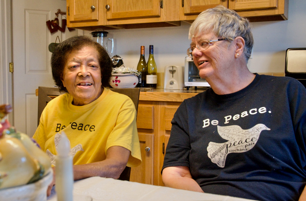 Mabel Harris Thomas (left), affectionately known as "Miss Mabel," and Dominican Sr. Pat Thomas talk in Miss Mabel's kitchen about her love for the Peace Center in the New Orleans neighborhood where she lives. (GSR photo/Dan Stockman)
