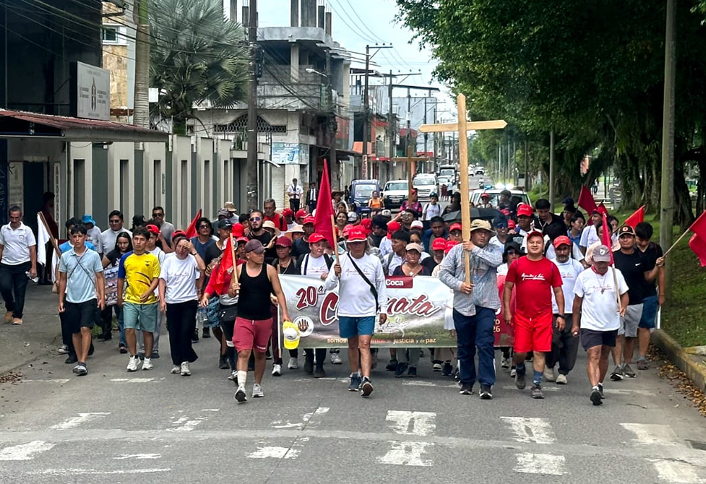 Bishop Adalberto Jiménez, apostolic vicariate of Aguarico, Ecuador, carries a cross on a pilgrimage from Quito to Coca, Ecuador, in honor of Bishop Alejandro Labaka Ugarte and Sr. Inés Arango Velásquez. (Courtesy of Sr. Winifred Doherty)