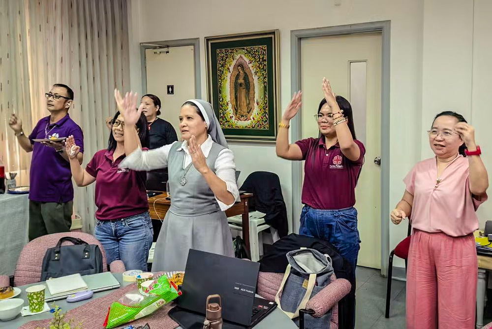 Sr. Ingkie Veloz Taboclaon leads a quick stretch and dance to keep the energy up during a Caritas Philippines workshop. (Facebook/Courtesy of Ingkie Veloz Taboclaon)