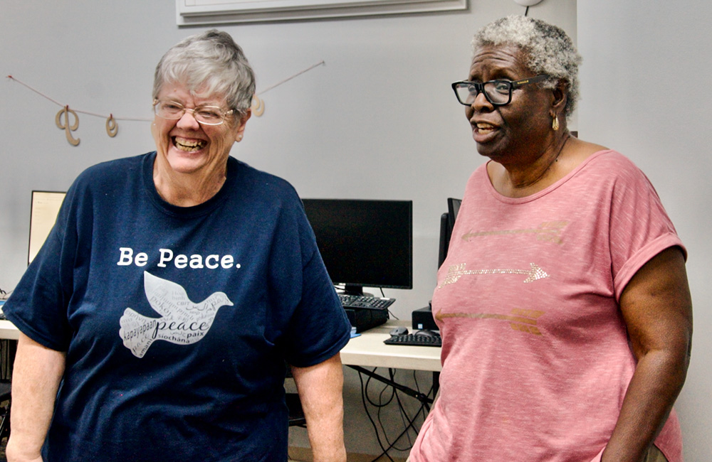 Sr. Pat Thomas (left) and Marcia Freeman share a laugh in the Peace Center, a ministry of the Dominican Sisters of Peace in the New Orleans neighborhood of Gert Town. (GSR photo/Dan Stockman)