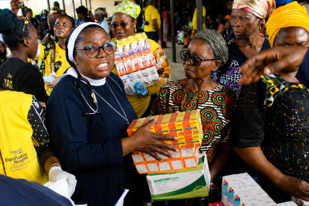 Sr. Dr. Margaret Ogunkuade, a Sister of St. Michael the Archangel, distributes nutrients and medications during a community health outreach in Ketu, Nigeria. (Courtesy of Margaret Ogunkuade)