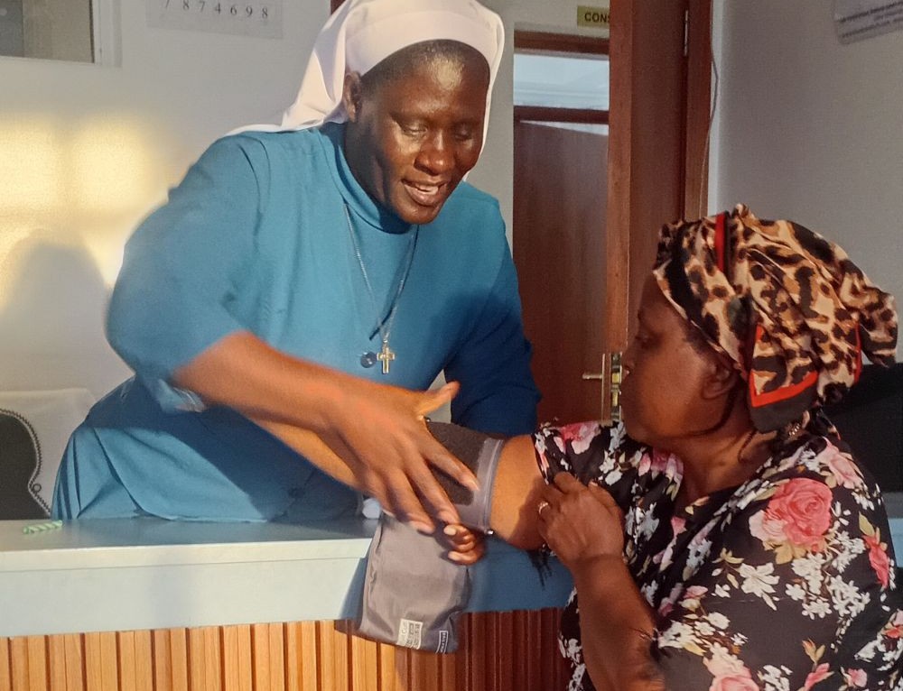 Sr. Teresa Barongo, a member of the Assumption Sisters of Eldoret and a nurse at the Dorothea Health Centre, greets a patient in Nairobi, Kenya. (Shadrack Omuka)