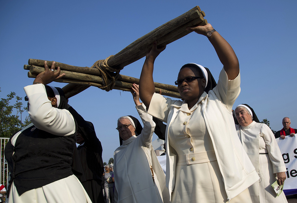 Nuns carry a cross during a silent march during Good Friday celebrations in Durban, South Africa, March 25, 2016. (CNS/Reuters/Rogan Ward)
