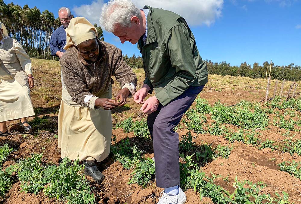 Sister Veronica, a member of the Little Sisters of St. Francis, shows a representative of the U.S. International Development Finance Corporation produce from the Divine Mercy Green Farm her order operates in Nakuru, Kenya. (CNS/Handout, Missio Invest, Pontifical Missionary Societies in the United States)