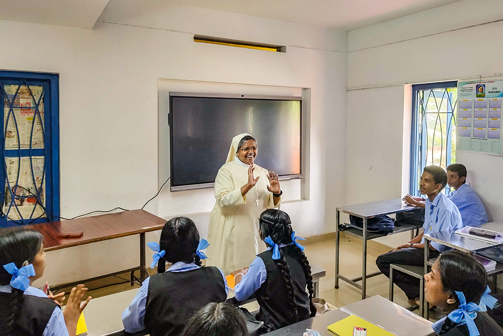 Sr. Alice Kasmel Vadakkethundil, member of the Daughters of Our Lady of Mercy, interacts with students at Karuna Speech and Hearing Higher Secondary School in Kozhikode, a town in the southwestern Indian state of Kerala. (George Kommattam)
