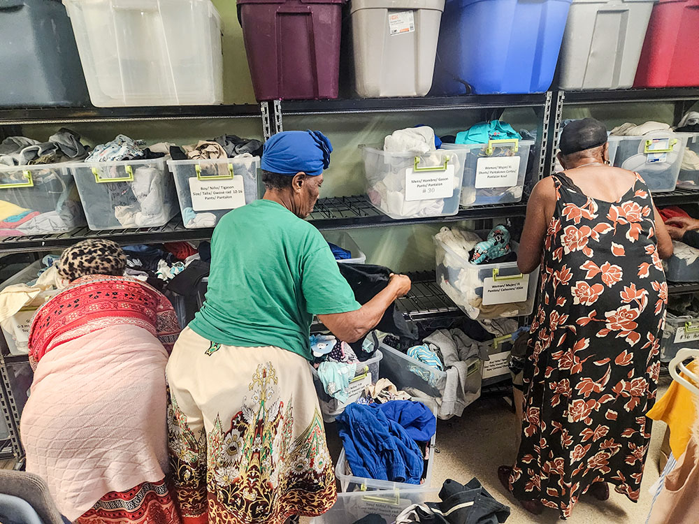 Haitian women sort through donated clothing at Catholic Charities in Immokalee, Florida. (GSR photo/Chris Herlinger)