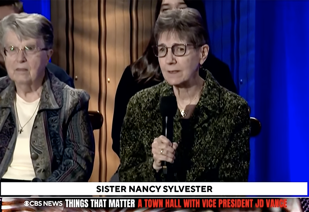 IHM Sr. Nancy Sylvester asks Vice President JD Vance a question about immigration enforcement at a town hall Oct. 17 in Detroit. (GSR screen capture)