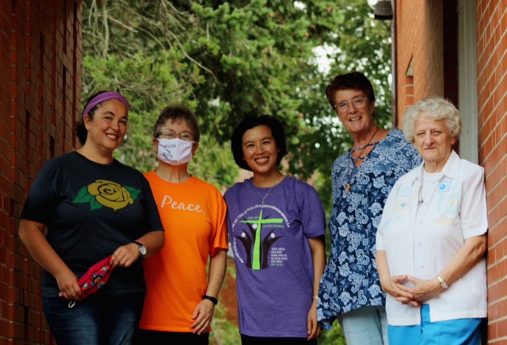 Outside the back door of the New Haven Dominicans of Peace convent, from left, Srs. Ana Gonzalez, June Fitzgerald, Lovers of the Holy Cross Sr. AnHoa Nguyen (a visiting scholar from Vietnam), Dominican candidate Cathy Buchanan, and Sr. Julia Grey