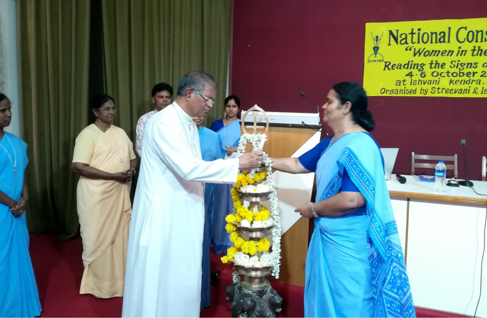 Bishop Thomas Dabre opens the October national consultation on "Women in the Church: Reading the Signs of the Time" at Ishvani Kendra in Pune, India. Holy Spirit Sr. Jaisa Antony assists him. (Saji Thomas)