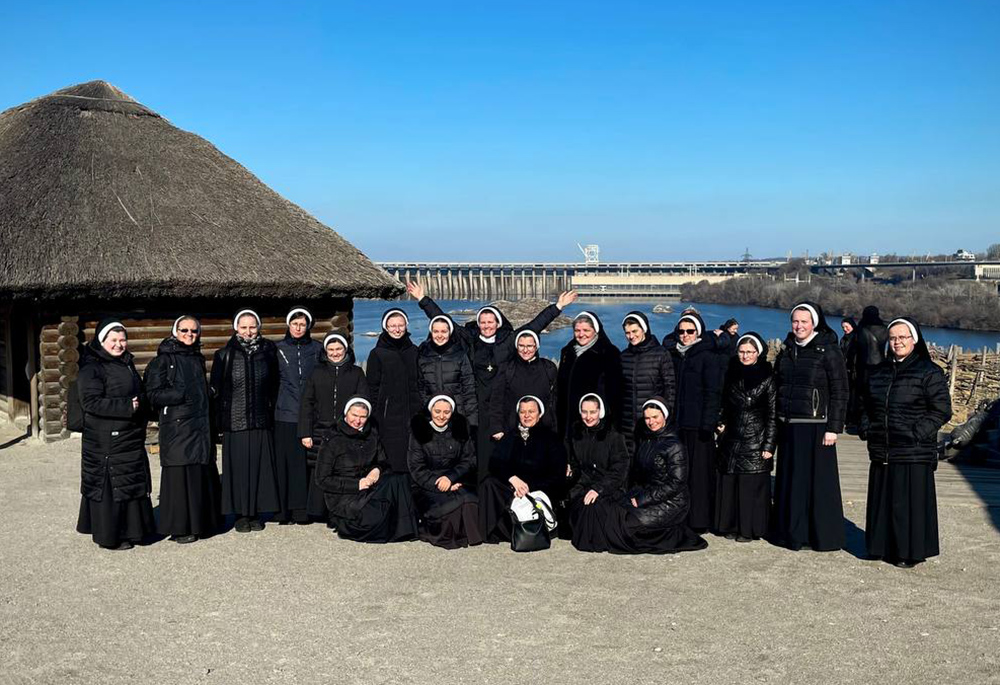 Basilian sisters on the monastic pilgrimage are pictured on the island of Khortytsia, with the Dnipro or Dnieper River behind them. The pilgrimage finished just before Russia invaded Ukraine. (Courtesy of Yeremiya Steblyna)