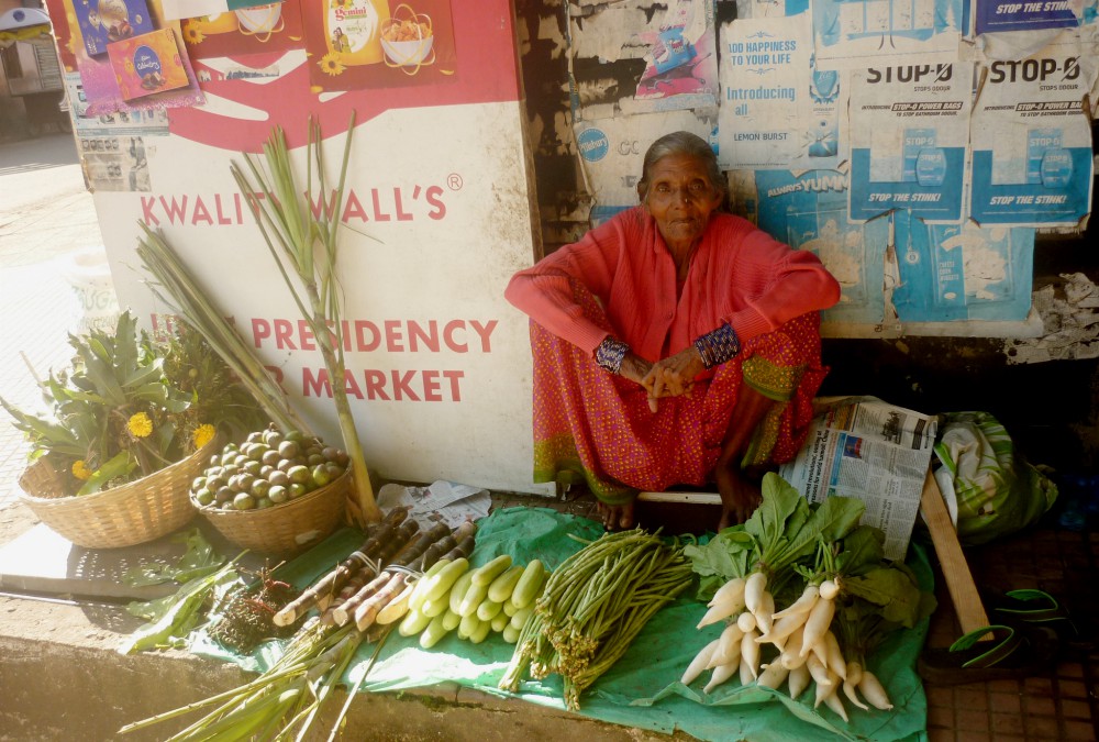 An elderly migrant woman manages a stall where she sells vegetables in Fontainhas, Panaji, capital of Goa, a western Indian state. (Lissy Maruthanakuzhy)