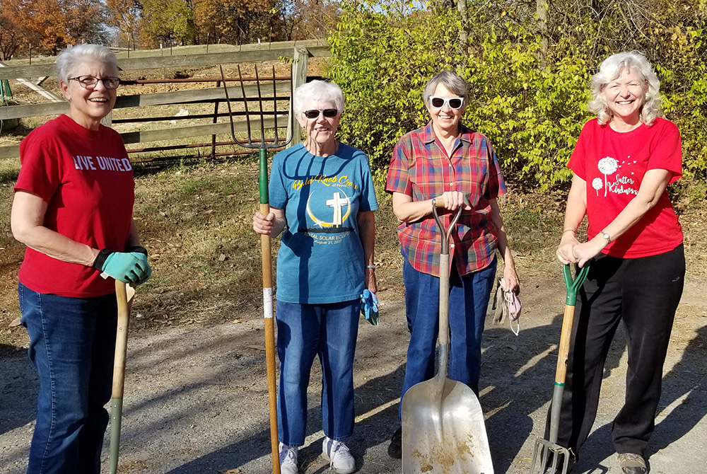 Sr. Anna Marie Reha, 60, far right, a provincial councilor for the School Sisters of Notre Dame, helps, from left, Barbara Neist, 74, Nancy Flamm, 77, and Rose Rita Huelsmann, 77, in October 2020, preparing the gardens in St. Louis for winter. (Courtesy o