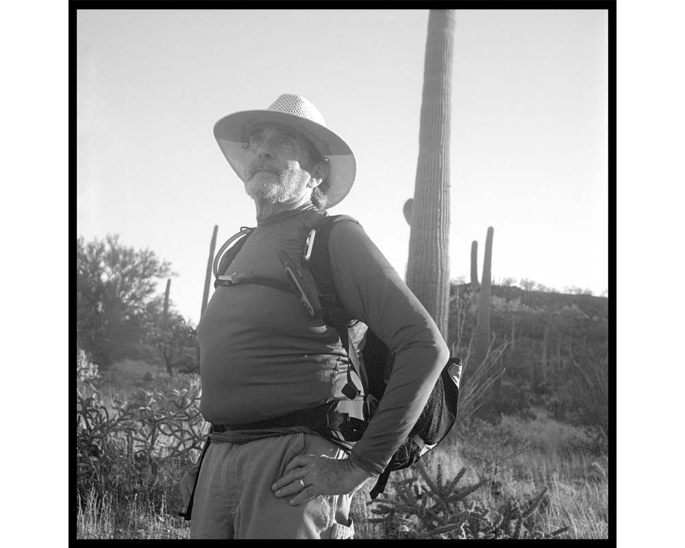 Bob Hunkler is ready for the hard day's work of walking in the desert uplands and carrying gallons of water in his backpack. Samaritan volunteers, many of whom are health care or business people, are doing mostly "grunt" work, filling up the trucks with f