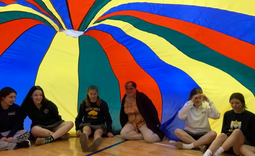 Jennifer Wilson, third from right, sits with students at Mount Mercy Academy in Buffalo, New York. (Courtesy of Mike Hardy)