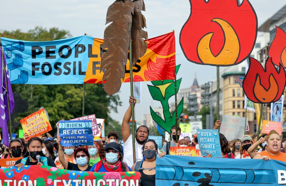 Environmental activists march to the U.S. Capitol during an Oct. 15, 2021, climate change protest in Washington. (CNS/Reuters/Evelyn Hockstein)