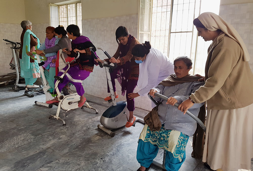 Sisters of Charity of St. Jeanne-Antide Thouret supervise a physiotherapy session for residents at Dar ul-Karishma. (Kamran Chaudhry)