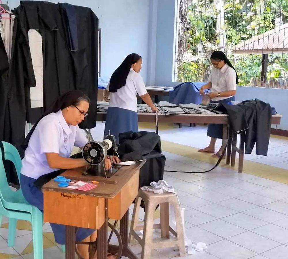 Catholic sisters in a workshop sewing masks