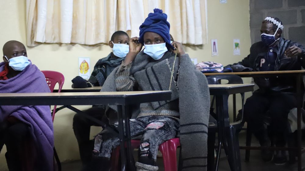 Boys who are herders attend a class at the Good Shepherd Night School in Semonkong, Lesotho, while maintaining social distance and wearing masks to protect themselves from COVID-19. The sisters started the school to cater to boys.