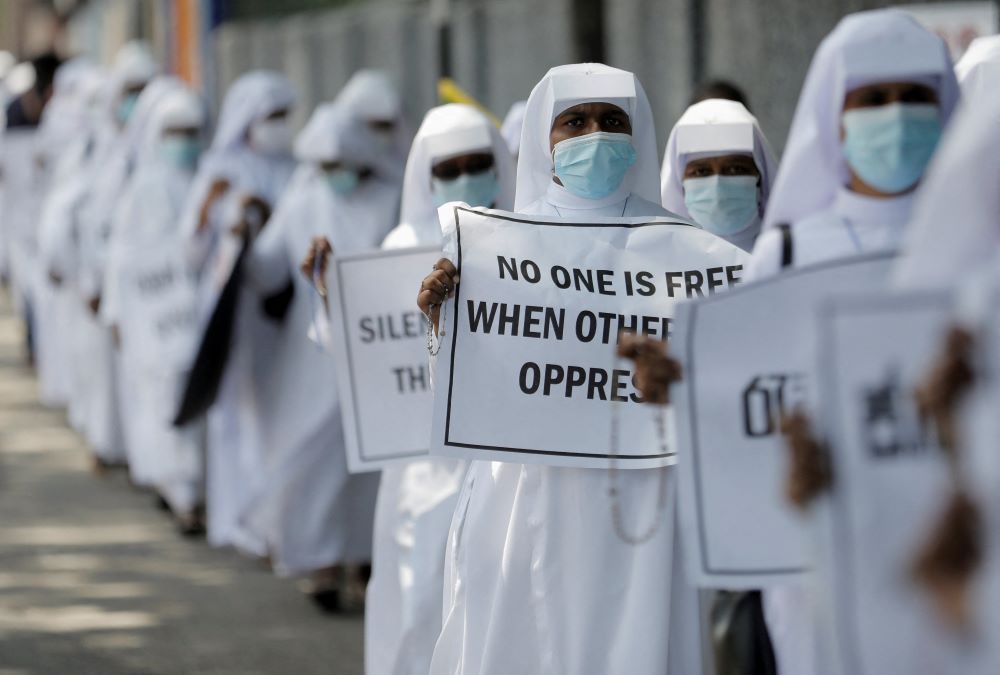 Nuns hold placards during a protest demanding Sri Lankan President Gotabaya Rajapaksa step down in Colombo April 5. Rajapaksa is trying to stabilize his government after protests prompted most of his Cabinet to resign. (CNS/Reuters/Dinuka Liyan)
