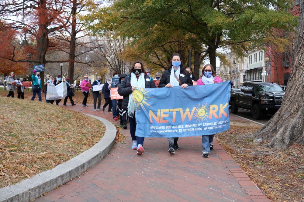 From left: Humility of Mary Sr. Eilis McCulloh, St. Joseph Sr. Erin McDonald, and Mercy Sr. Mara Rutten participate in a December 2021 demonstration at the White House that encouraged President Joe Biden to end Title 42.