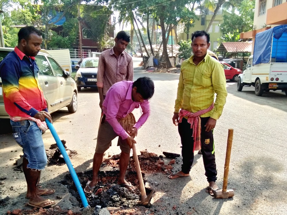 Migrant men repair a road in Mala, a village in Goa, western India. (Lissy Maruthanakuzhy)