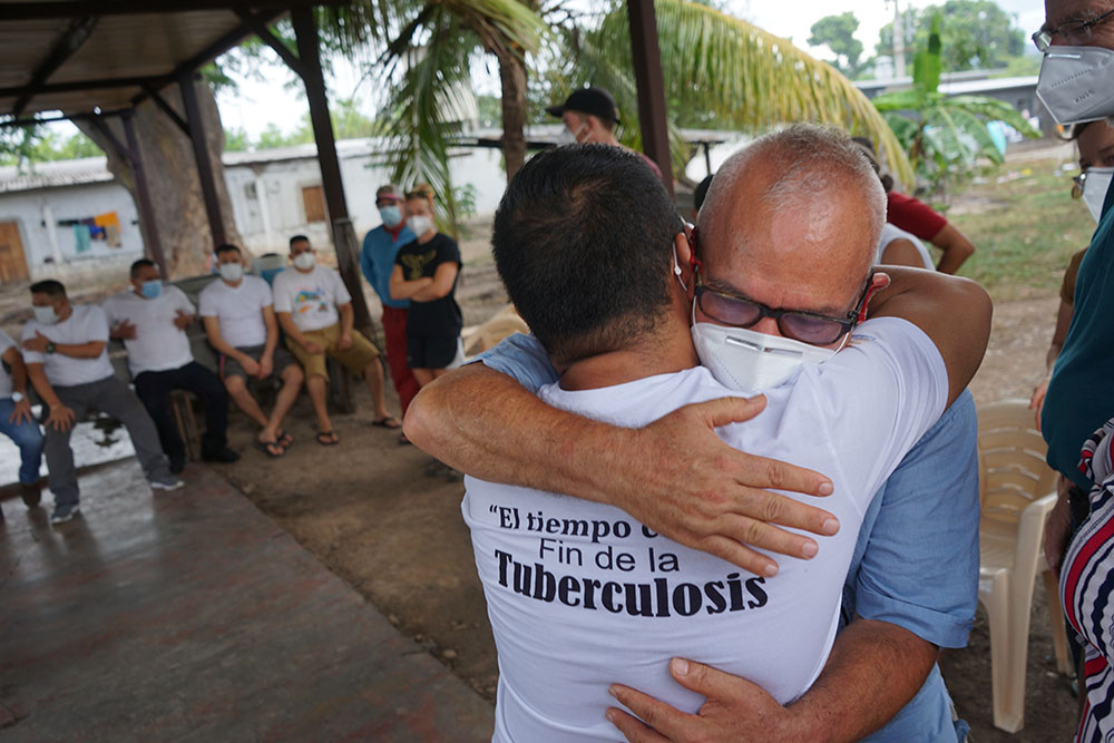 SHARE Foundation director and delegation leader Jose Artiga greets one of the members of the Guapinol 8 who has been incarcerated since 2019 without trial or options for bail. (Mark Coplan)
