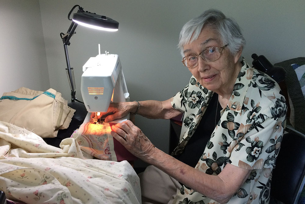 Sr. Jane Gates, MD, the first superior general of the Medical Mission Sisters after its founder. Sister Jane, 93 years old and a former surgeon, finds that her hands are still steady enough to sew gowns for medical care providers during the pandemic. (Eun