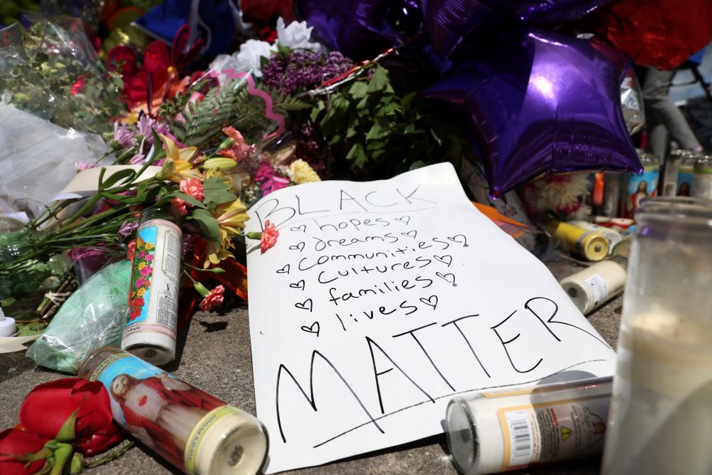 A memorial in Buffalo, New York, is seen May 17 in the wake of a weekend shooting at a Tops supermarket. A white man is accused of killing 10 people and injuring 3. Eleven of the victims were Black. (CNS/Reuters/Brendan McDermid)