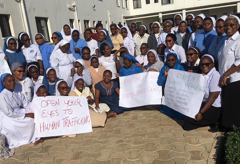 Sisters from across Zambia attended a workshop in November 2021 in Makeni, Lusaka, on advocacy against human trafficking. The sisters stand with the signs they made as part of their awareness-raising efforts. (Sr. Eucharia Madueke)