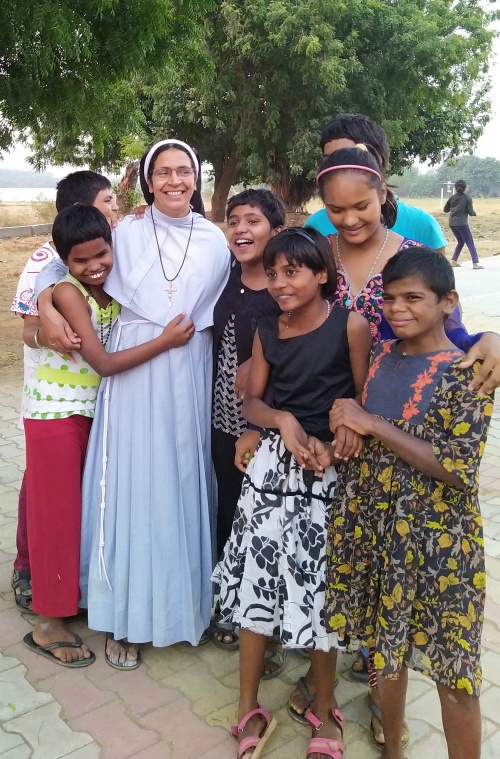 Clarist Sr. Sherly Payappilly Koluvan, superior of Sehion House, plays with children inside Sanjoepuram Children's Village, which is managed by the Faridabad Syro-Malabar Eparchy at Chandpur, India. (Jessy Joseph)