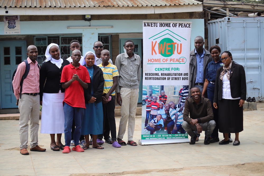 Srs. Caroline Ngatia, at left, in white veil, and Caroline Cheruiyot, far right, and members of the staff work together on behalf of the street children, some of whom are pictured here, at Kwetu Home of Peace in Nairobi, Kenya. (Doreen Ajiambo)