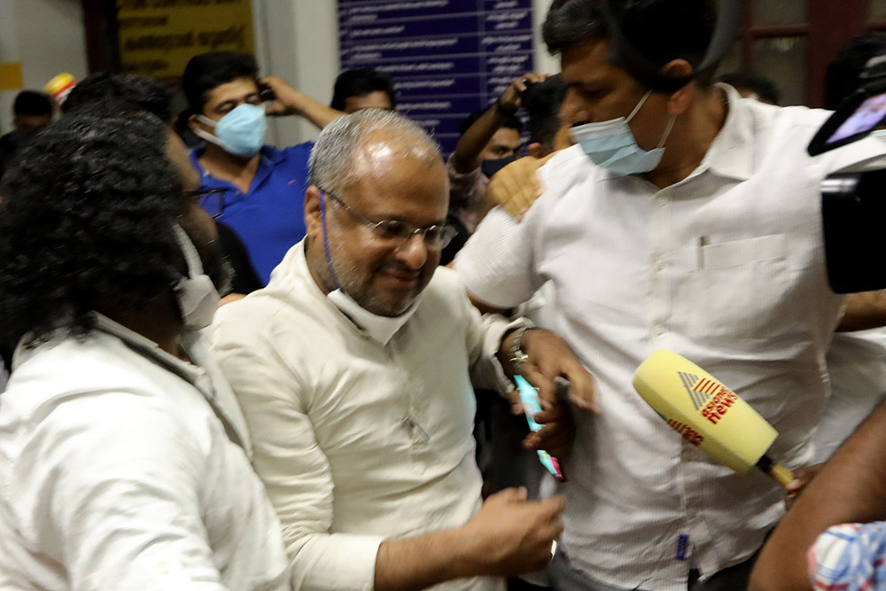 Bishop Franco Mulakkal, flanked by relatives, including, at right, his brother-in-law P.P. Chacko, goes to his car parked inside the compound of the Additional District and Sessions Court in Kottayam, Kerala, India, where he was acquitted on Jan. 14.