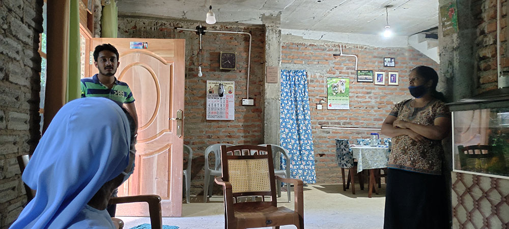 The newly expanded house of Meghala Thangavelu, whose husband works as a gardener in Saudi Arabia. Her son, Darshan Vinith Thangavelu, in doorway, wants to help other homeless people as he starts employment. (Thomas Scaria)